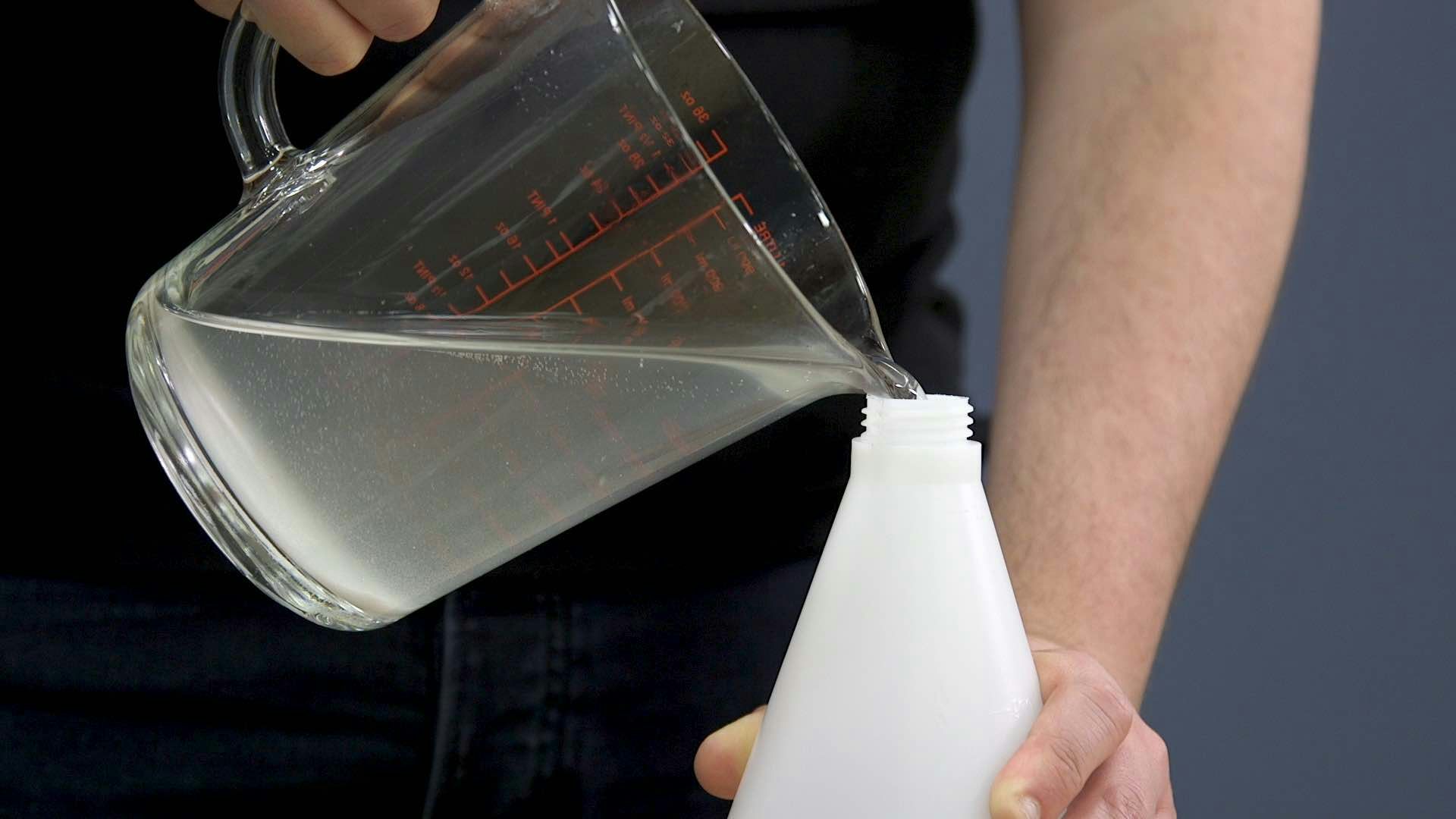 Pouring mixture into a spray bottle