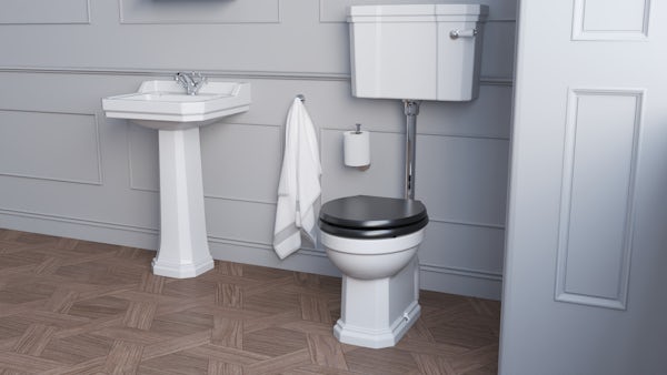 Ideal Standard low level toilet with ornate brackets and black toilet seat
