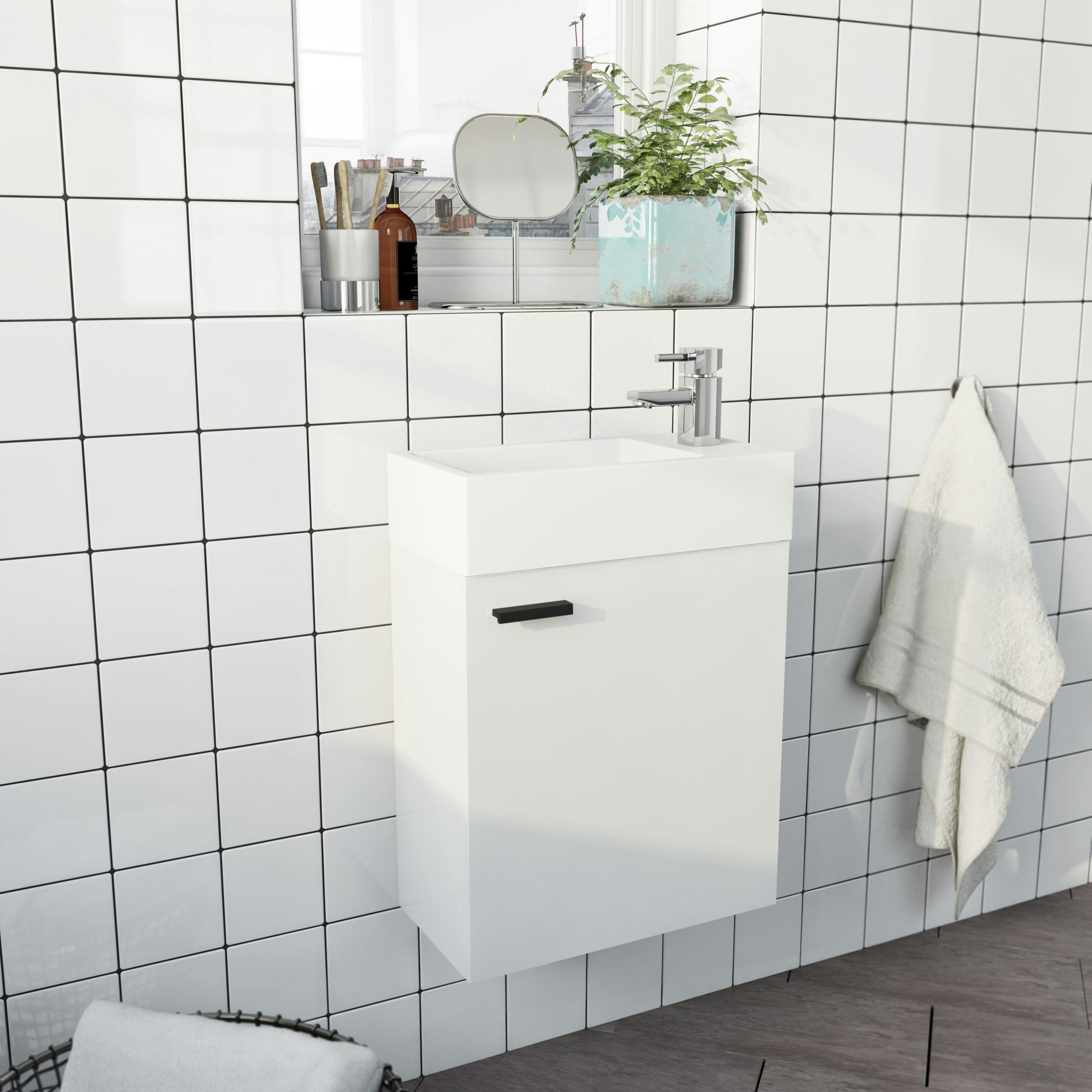 Clarity Compact white wall hung cloakroom suite with contemporary close coupled toilet and black handles